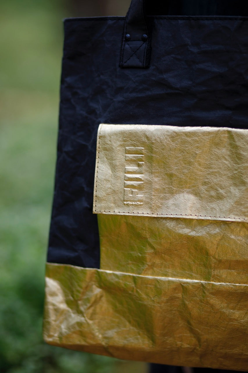 Fiilii design golden  logo on their golden black bag. 